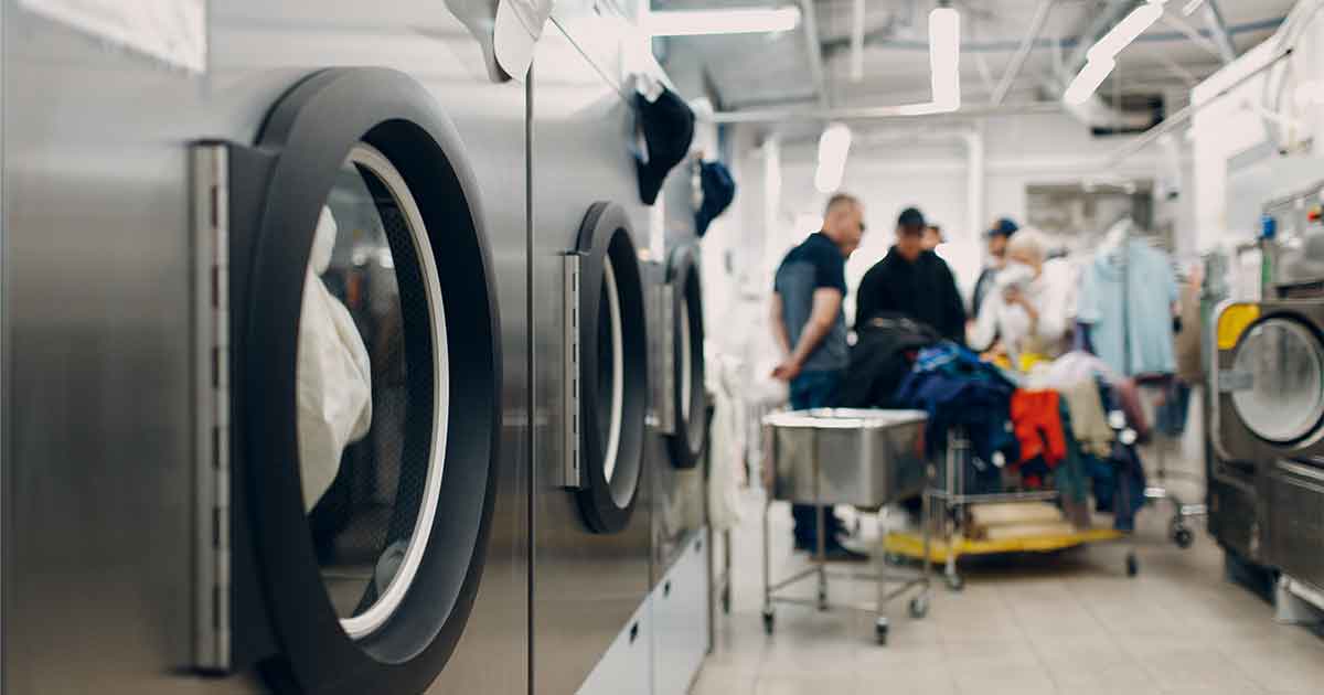 A group of people in a laundry room.